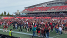 Fans pack the field at TD Place after the Gee-Gees beat the Ravens in the 53rd Panda Game at TD Place. (Natalie van Rooy/CTV News Ottawa)