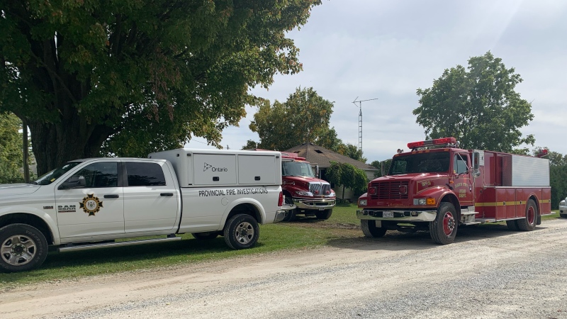 Investigators and fire crews on scene of a fatal house fire in Newbury, Ont. on Saturday, Oct. 1, 2022. (Brent Lale/CTV News London)
