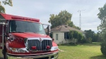 Investigators and fire crews on scene of a fatal house fire in Newbury, Ont. on Saturday, Oct. 1, 2022. (Brent Lale/CTV News London)