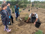 Tiago and Mia help plant a tree at Lemoine Pointe in Kingston, Ont. (Kimberley Johnson/CTV News Ottawa) 
