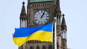 The flag of Ukraine is seen beside the Peace Tower on Parliament Hill in Ottawa, on March 15, 2022. THE CANADIAN PRESS/Justin Tang
