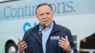 Coalition Avenir Quebec Leader Francois Legault speaks to reporters during an election campaign stop in L'Assomption, Que., Sunday, September 25, 2022. Quebecers will go to the polls on October 3rd. THE CANADIAN PRESS/Graham Hughes