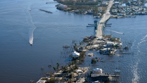 The bridge leading from Fort Myers to Pine Island, Fla., is seen heavily damaged in the aftermath of Hurricane Ian on Pine Island, Fla., on Oct. 1, 2022. Due to the damage, the island can only be reached by boat or air. (AP Photo/Gerald Herbert)