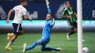 Vancouver Whitecaps' Lucas Cavallini (9) scores against Austin FC goalkeeper Brad Stuver during the second half of an MLS soccer game in Vancouver, on Saturday, October 1, 2022. THE CANADIAN PRESS/Darryl Dyck