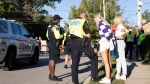 Students take part in parties and gatherings in a neighbourhood around Western University in London, Ont. with an increased police presence during the school's homecoming weekend on Saturday, September 25, 2021.THE CANADIAN PRESS/Nicole Osborne 