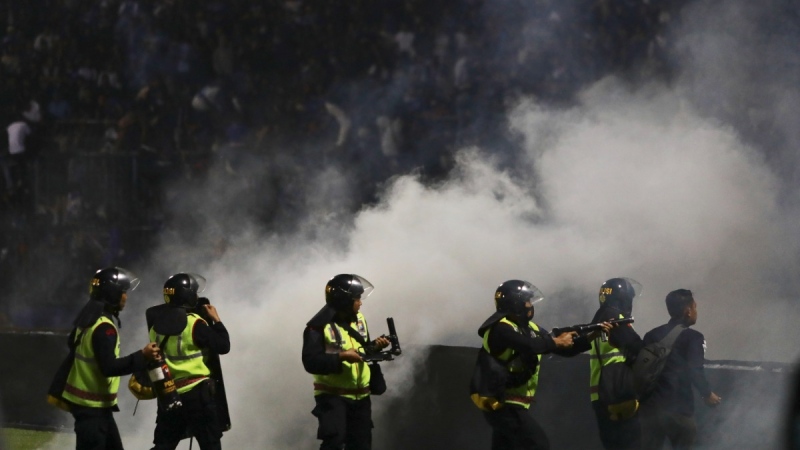 Police officers fire tear gas during a soccer match at Kanjuruhan Stadium in Malang, East Java, Indonesia, on Oct. 1, 2022. (Yudha Prabowo / AP)
