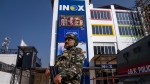 A paramilitary soldier stands guard outside the first multiplex cinema of Kashmir in Srinagar, Indian controlled Kashmir, Friday, Sept. 30, 2022. The multi-screen cinema hall has opened in the main city of Indian-controlled Kashmir for public for the first time in 14 years. The 520-seat hall with three screens opened on Saturday, Oct. 1, amid elaborate security but only about a dozen viewers lined up for the first morning show. (AP Photo/Dar Yasin)