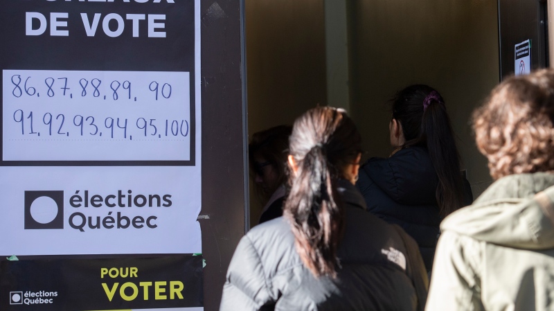 People wait in line to vote on Quebec election day in Montreal, Monday, October 3, 2022. THE CANADIAN PRESS/Graham Hughes
