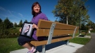 Carol Todd holds a photograph of her late daughter Amanda Todd while sitting on a bench dedicated to her at Settlers Park in Port Coquitlam, B.C., Oct. 5, 2013. THE CANADIAN PRESS/Darryl Dyck