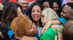 Quebec Liberal Party leader Dominique Anglade, centre, is hugged by local candidates following a news conference while on an election campaign stop in Montreal, Saturday, October 1, 2022. Quebecers will go to the polls on October 3rd. THE CANADIAN PRESS/Graham Hughes