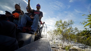 Residents evacuate by airboat through floodwaters along the Peace River in the aftermath of Hurricane Ian in Arcadia, Fla., Oct. 3, 2022. (AP Photo/Gerald Herbert)
