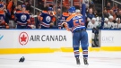 Edmonton Oilers' Dylan Holloway (55) celebrates a hat trick against the Vancouver Canucks during third period preseason action in Edmonton on Monday, October 3, 2022. THE CANADIAN PRESS/Jason Franson