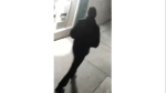 In this undated surveillance image released by the Stockton Police Department, a person is shown from behind, in Stockton, Calif. Rewards have been offered for information leading to an arrest in five fatal shootings since July in Stockton. (Stockton Police Department via AP)