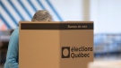 A woman votes at a polling station in Quebec City, Monday, October 3, 2022. THE CANADIAN PRESS/Jacques Boissinot