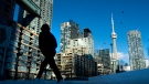 Condo towers dot the Toronto skyline as a pedestrian makes his way through the COVID-19 restricted winter landscape on Thursday January 28, 2021. THE CANADIAN PRESS/Frank Gunn