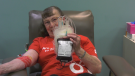 Josephine Michaluk, 76, from Penhold in central Alberta, poses for a picture with her 203 blood donation in Red Deer.