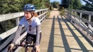 Kate Mason rides her bike in a promotional video the fundraiser. (Source: Hospice Halifax/Facebook)