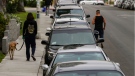 In this Friday, May 22, 2020, a line of vehicles are parked in Los Angeles. The coronavirus hasn't been kind to car owners. With more people than ever staying home to lessen the spread of COVID-19, their sedans, pickup trucks and SUVs are parked unattended on the streets, making them easy targets for opportunistic thieves. (AP Photo/Damian Dovarganes)