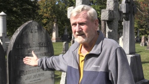 Author Brian "Chip" Martin shows the gravestone of slave owner Gabriel Manigault who found refuge in London, Ont., as seen on Oct. 4, 2022. (Daryl Newcombe/CTV News London)