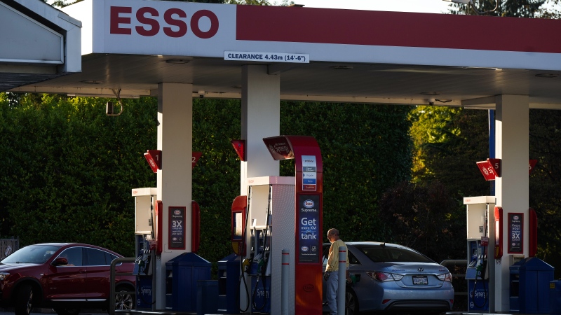 A motorist fuels up a vehicle at an Esso gas station after the price of a litre of regular gasoline reached a new high in Vancouver, on Saturday, October 1, 2022. THE CANADIAN PRESS/Darryl Dyck