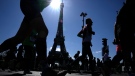 Competitors run in front of the Eiffel Tower during the Paris Marathon, on April 3, 2022. (Francois Mori / AP)