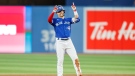 Toronto Blue Jays centre fielder Whit Merrifield (1) celebrates his double at second base in the seventh inning of their American League MLB baseball game against the Boston Red Sox in Toronto on Sunday, October 2, 2022. THE CANADIAN PRESS/Cole Burston