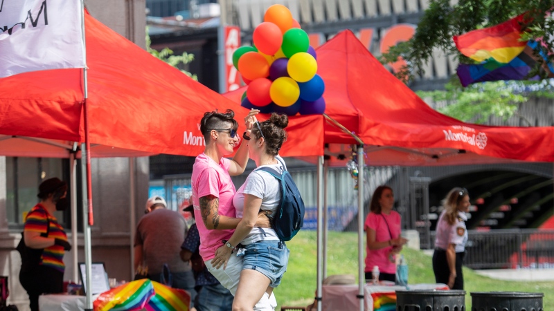 Florence, left, and Billie dance at the site where the Montreal Pride parade was supposed to start from in Montreal, Sunday, August 7, 2022. Festival organizers cancelled the parade over concerns for security due to the lack of staff. THE CANADIAN PRESS/Graham Hughes