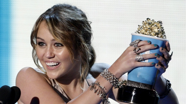 Miley Cyrus accepts the award for best song from a movie for "The Climb" featured in "Hannah Montana: The Movie" at the MTV Movie Awards on Sunday May 31, 2009, in Universal City, Calif. (AP Photo/Matt Sayles)
