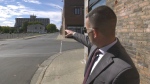 Aaron Bell of Rothmar Holdings points to a vacant property on First Street West in Cornwall, Ont., where development has been halted since December 2021. (Nate Vandermeer/CTV News Ottawa)