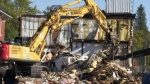  Crews tear apart building to remove truck 