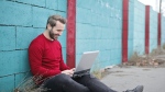 A man is seen smiling at his laptop. (Pexels file image) 