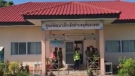 In this image taken from video, officials enter the site of an attack at a daycare centre, Oct. 6, 2022, in the town of Nongbua Lamphu, northeastern Thailand. (TPBS via AP)