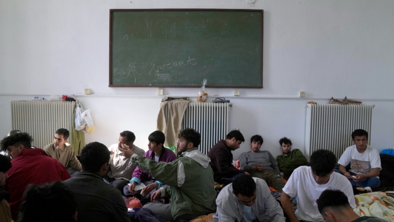 Migrants, most of them from Afghanistan, rest at an old school used as a temporary shelter on the island of Kythira, southern Greece, Oct. 6, 2022. (AP Photo/Thanassis Stavrakis)