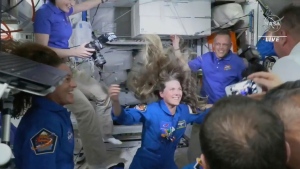 In this image from video made available by NASA, Russian Cosmonaut Anna Kikina enters the International Space Station from a SpaceX Crew Dragon capsule on Thursday, Oct. 6, 2022. Kikina is the first Russian to launch from the U.S., in 20 years. (NASA via AP)