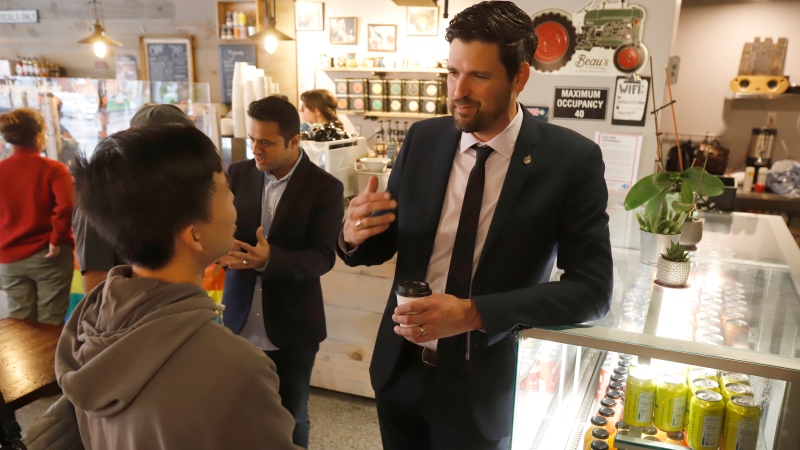 Minister of Immigration, Refugees and Citizenship Sean Fraser speaks with customers after making an announcement about international students and Canada’s labour shortage at Happy Goat Coffee in Ottawa on Friday, October 7, 2022. THE CANADIAN PRESS/ Patrick Doyle