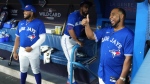 Former Blue Jays player Edwin Encarnacion gives a thumbs up as Blue Jays first baseman Vladimir Guerrero Jr. (27) and right fielder Teoscar Hernandez (37) look on during player introductions ahead of first inning American League, wild card MLB post season baseball action in Toronto on Friday, October 7, 2022. 
