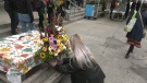 Several flowers were displayed and handed out to people who attended the memorial service at the Covent Garden Market in London, Ont. on Friday, Oct. 7, 2022. The memorial honoured the lives of 57 people who died as a result of homelessness in London. (Jenn Basa/CTV News London)