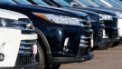This Nov. 15, 2020 photo shows a row of unsold used Highlander sports-utility vehicles sitting at a Toyota dealership in Englewood, Colo. (AP Photo/David Zalubowski)