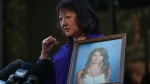 Composite photo of Carol Todd holding a photo of her late teenage daughter Amanda Todd, who died by suicide in 2012, and the necklace she was wearing in the school photo, outside B.C. Supreme Court after sentencing for the Dutch man who was accused of extorting and harassing her daughter, in New Westminster, B.C., on Friday, October 14, 2022. THE CANADIAN PRESS/Darryl Dyck 