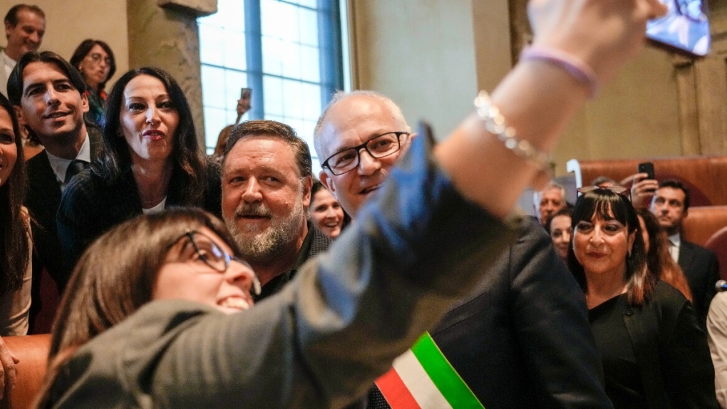 Russel Crowe, centre, poses for photos in Rome