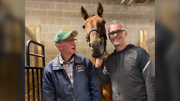 Denny and Jayson Baxter are seen with their beloved racehorse, "Samspace," or Sammy. 