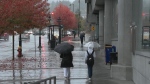 People walk in the rain in Vancouver. 