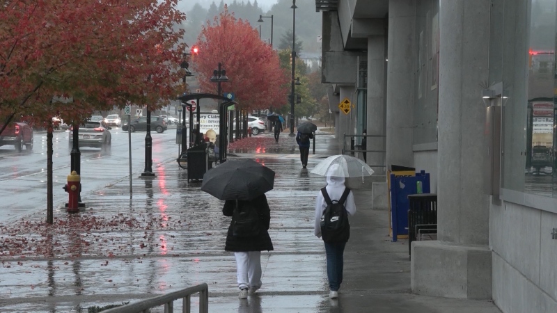 People walk in the rain in Vancouver. 