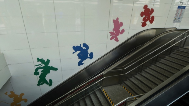 Disney characters are seen on a wall next to the escalator inside a closed subway station at the Shanghai Disney Resort in Shanghai, China, Nov. 1, 2021. (Chinatopix via AP)