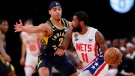 Brooklyn Nets guard Kyrie Irving (11) drives to the basket against Indiana Pacers guard Andrew Nembhard (2), in New York, Oct. 29, 2022. (Noah K. Murray / AP)
