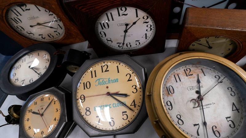 A selection of vintage clocks are displayed at Electric Time Company, Tuesday, Nov. 1, 2022, in Medfield, Mass. Daylight saving time ends at 2 a.m. local time Sunday, Nov. 6, 2022, when clocks are set back one hour. (AP Photo/Charles Krupa)