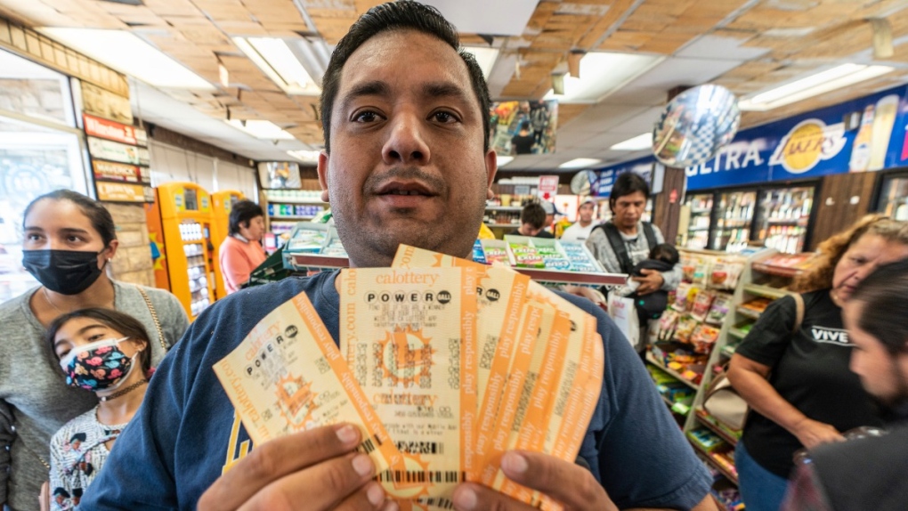 Hector Solis holds up lottery tickets
