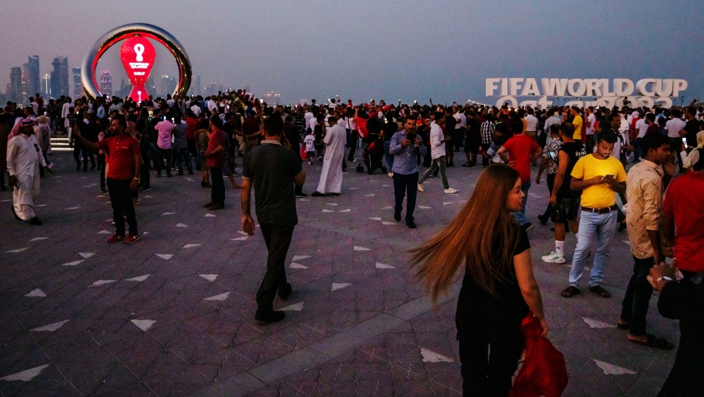 People roam near FIFA World Cup clock.