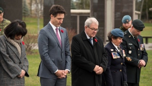 Prime Minister Justin Trudeau, Lawrence MacAulay, MP and Minister of Veterans Affairs and Anita Anand, Minister of National Defence, participates in a moment of silence at the Field of Honour memorial at the Oromocto Pioneer Gardens in Oromocto, New Brunswick on Tuesday November 8, 2022. THE CANADIAN PRESS/Stephen MacGillivray