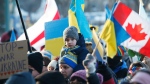 Thousands of people rally in support of the Ukraine outside the Manitoba Legislature in Winnipeg Saturday, February 26, 2022. THE CANADIAN PRESS/John Woods